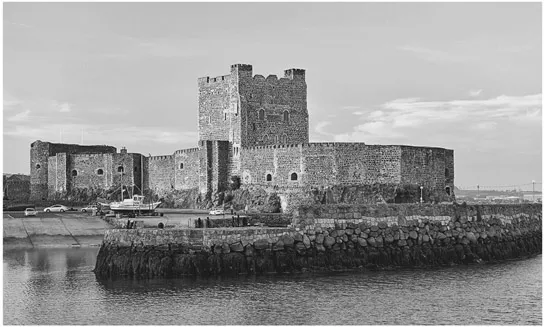 PLATE 1.2 Carrickfergus Castle, Northern Ireland. The Norman castle lies on the North Antrim Coast Road by the shore of Belfast Lough. It was founded in 1177 by John de Courcy and completed by Hugh de Lacy in 1205. William III landed here in 1690 before travelling to Belfast and later to the Battle of the Boyne. © David Lyons/Alamy