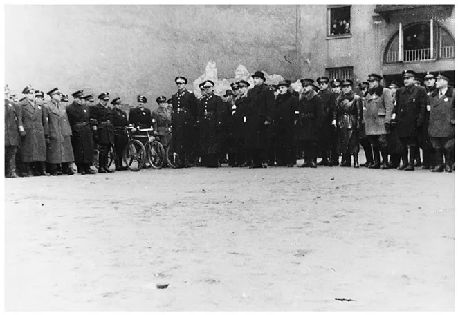 Figure 3. Adam Czerniaków (in a bowler hat) with functionaries of the Jewish Order Service and the Polish Blue Police, late 1941. Source: JHIA, ARG I 683-58.