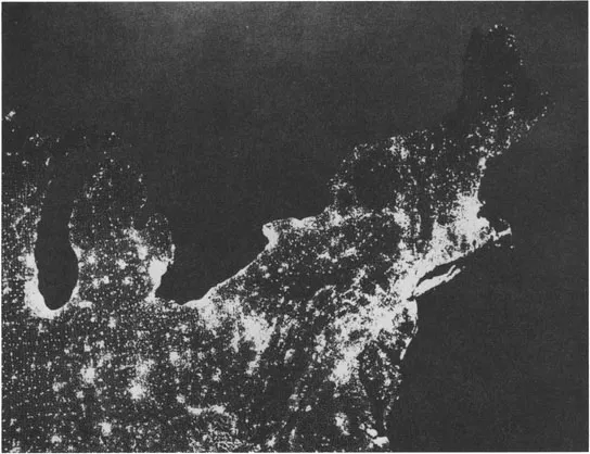 FIGURE 1.2. Nighttime Census Map. On viewing nighttime satellite photos showing cities as brilliant spots of light against the darker countryside, census officials realized that a satellite photo was very like a negative of the census dot-map of population distribution. This map negative highlights the continuous interlinkage of the northeastern megalopolis much as it might appear to astronauts seeing it at night. (U.S. Bureau of the Census)