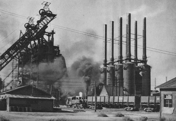 Figure 1.2 Modern industrial buildings at Anshan steel foundry, near Fushun, showing the 350-tonne steel furnace (left) and blowers (right).