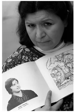 Photo 1.2 Dolly Filartiga With a Picture of Her Brother Joelito Source: © Associated Press