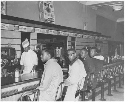 Figure 1.1 The second day of the Greensboro sit-in; from left, Joseph McNeil, Franklin McCain, Billy Smith, and Clarence Henderson. (Credit: Greensboro News and Record)