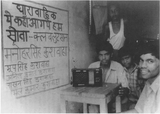 Photo 1.3. A hand-painted sign in Village Lutsaan in July 1998 promoting Yeh Kahan Aa Gaye Hum (Where Have We Arrived?), the successor radio soap opera about the environment following Tinka Tinka Sukh. The sign lists some members of the newly formed radio listeners’ club, established since the first visit of our research team to Lutsaan in August 1997. (Source: Personal files of the authors.)