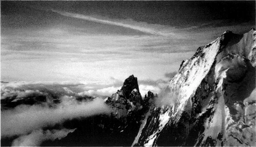 Figure 1.1 Peuterey Ridge and Aiguille Noir, Mont Blanc, September 1981. The scale of exposure that our buildings have to cope with is easily forgotten, and our climatic extremes are often peaks in an undulating chart of annual variations. If we catered for the worst possible conditions, our buildings would be better equipped for survival. (Photograph: Steve Keates.)