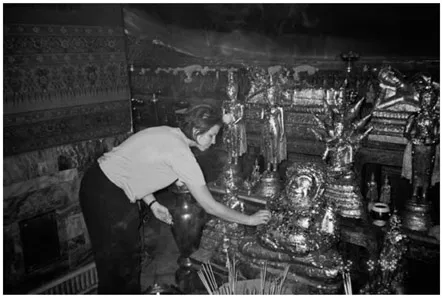 PHOTO 1.2. Author Kerry Hughes at a Buddhist temple in Thailand with incense offering.