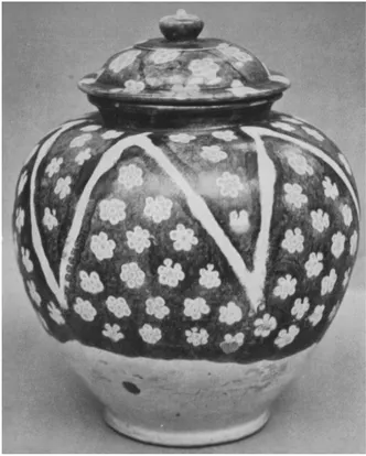 PLATE X
COVERED JAR: EARTHENWARE: CHEVRON DESIGNS IN COLOUR T'ANG DYNASTY (A.D. 618-906) H. 10·15 in. British Museum, London (Eumorfopouhs Collection)