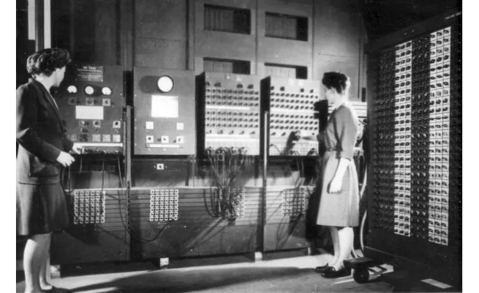 Figure 1.2: Betty Jean Jennings and Fran Bilas, both programmers, operate ENIAC's main control panel – U. S. Army Photo (Public Domain [PD])