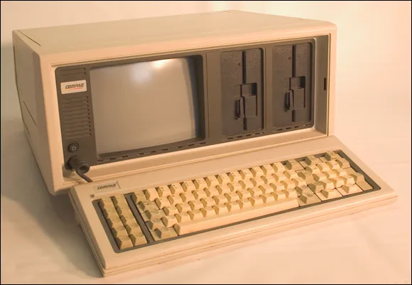 Photo depicts the luggable Compaq Portable.