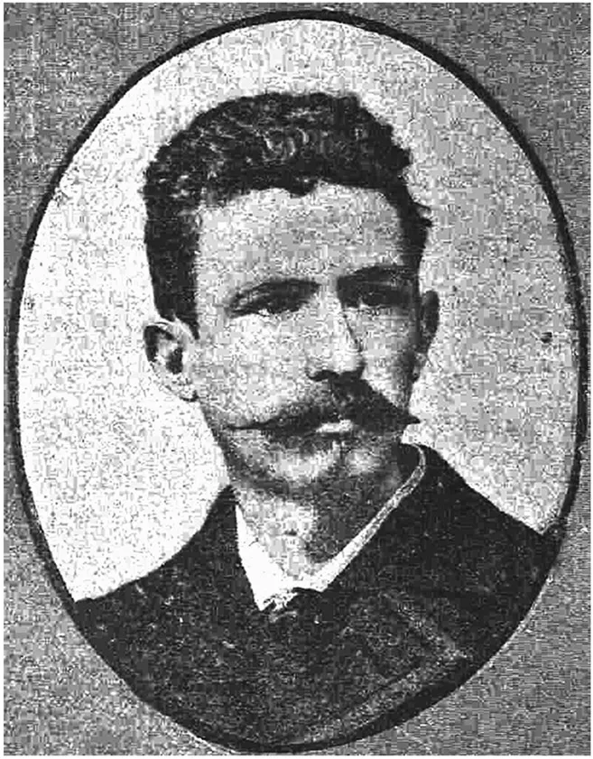A man with a long, narrow mustache and a narrow nose looks off to the side of the camera.