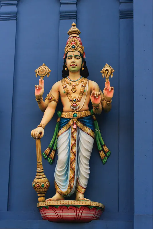 Statue of Hindu god Vishnu on temple wall