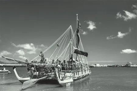 A photo shows a traditional New Zealand canoe with oarsmen aboard.