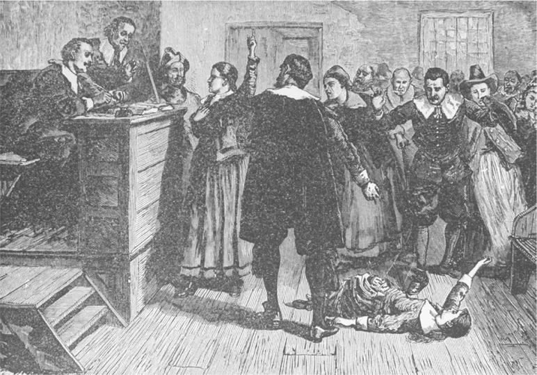 An engraving of a witch trial in Salem with a woman on the floor in front of the judges and two men standing over her. A woman stands at the judges’ bench, protesting.