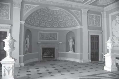 Formal entry hall of 1770s English mansion with arches, vaults, coffers, a fireplace and classical statuary