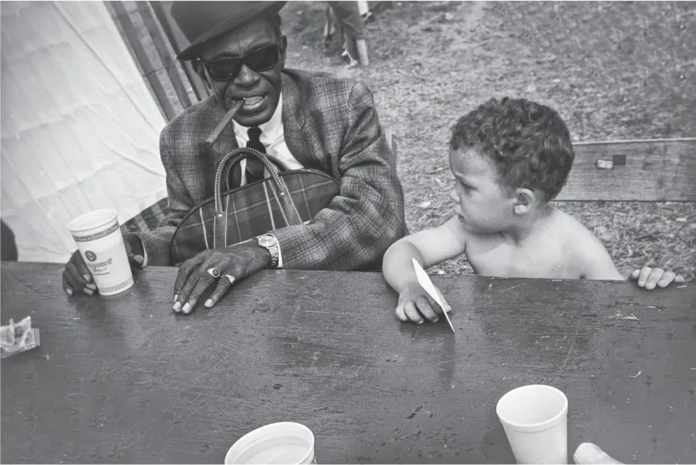 14. Sam “Lightnin’ ” Hopkins (blues singer) and Michael Lee Jackson, Newport Folk Festival performers’ tent. Newport, Rhode Island, 1965.