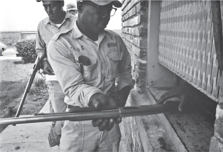 4. Convict guards returning weapons to armory. Cummins prison farm, Varner, Arkansas, 1971.