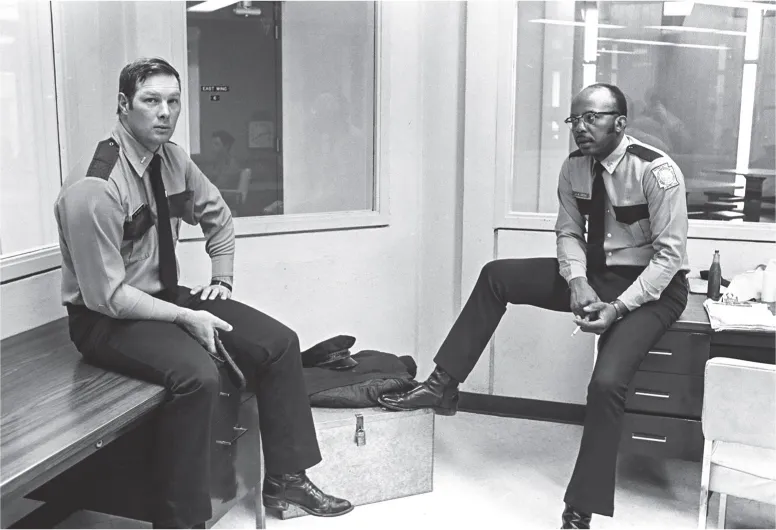 5. Lieutenant (with blackjack) and sergeant (with cigarette) in control picket, Maximum Security building. Cummins prison farm, Varner, Arkansas, 1974.