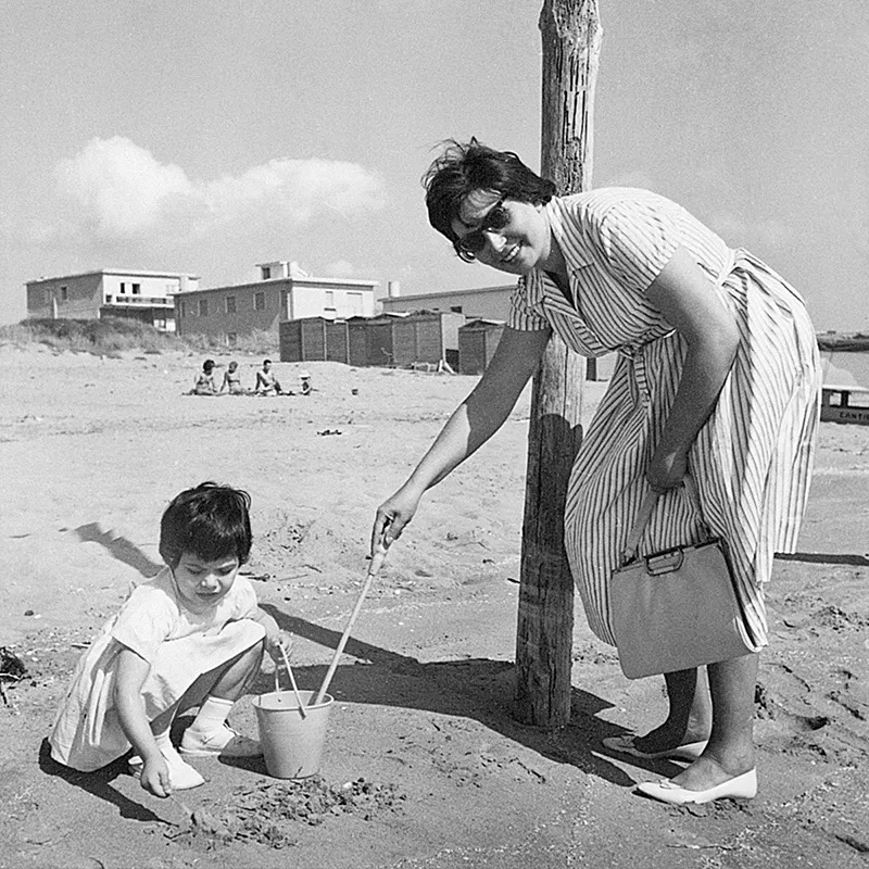 Giochi con la sabbia in spiaggia con la mamma.