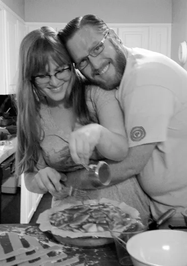 A photo shows Kirsten Andersen Morris and Scott Russell Morris posing together behind the kitchen counter.