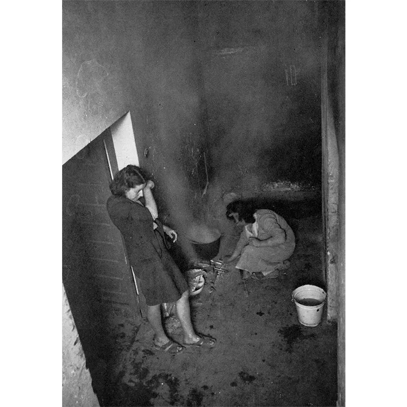 Due donne preparano una minestra in una cucina improvvisata, nel corridoio di uno stabile che ospita gli sfollati.