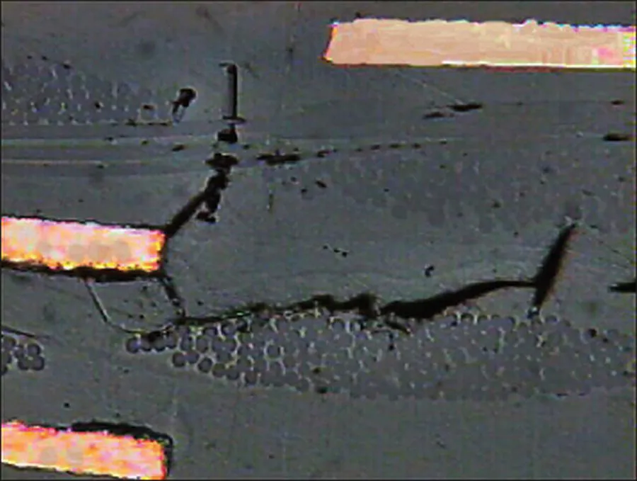 Schematic illustration of cohesive failures beside plated through holes on copper clad laminates, which used to be produced by thermal stress.