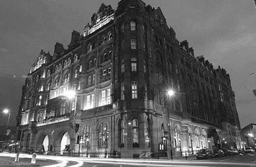 Photo of a floodlit hotel in Manchester at night.