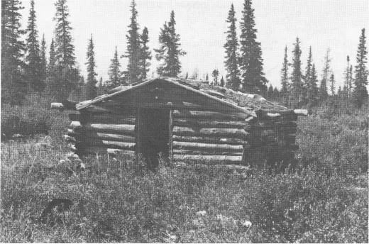 Photograph showing Chipewyan winter cabin made of wood on North Knife River.