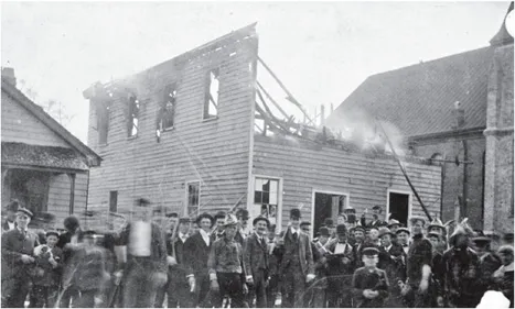 A postcard produced by local photographer Henry Cronenberg documented the destruction of Love and Charity Hall, which housed the Daily Record, Wilmington’s black newspaper. Courtesy of the New Hanover County Public Library, Robert M. Fales Collection.