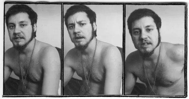 A series of three photographs of a man from the waist up who is sitting. They are shirtless and wearing a long necklace. They have long sideburns and a short-cropped beard and moustache. Their hair is dark coloured and they are staying into the camera in each photograph with slightly different facial expressions. In the last photograph it looks like he is about to say something.