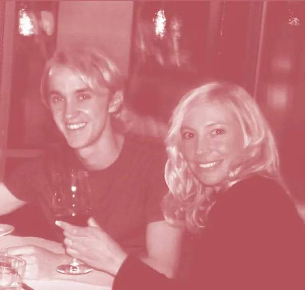 Author Erin Pyne and Tom Felton, who played Draco, sit together and smile in the Three Broomsticks.