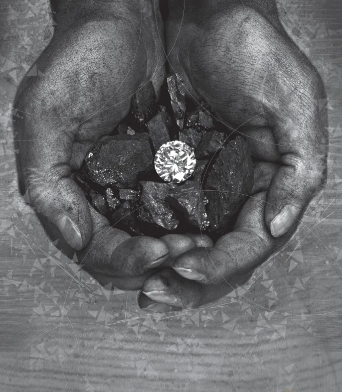 Photograph depicts two human hands holding a diamond and coal.