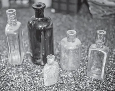 Photograph of five medicine bottles of different shapes and sizes, used by Dr. Price.